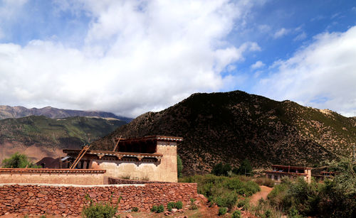 House on mountain against sky