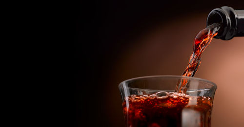 Close-up of wine pouring in glass