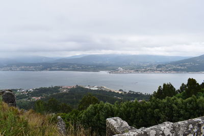 Scenic view of sea and mountains against sky