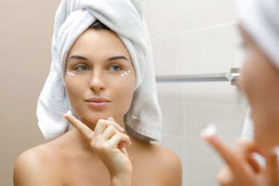 Portrait of young woman in bathroom