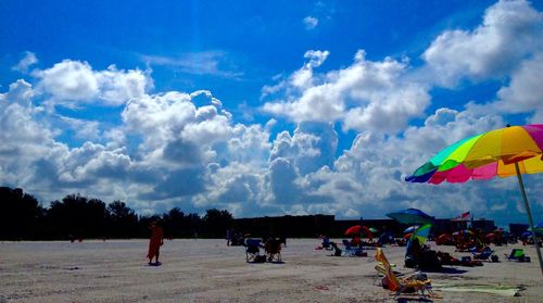 People enjoying against cloudy sky