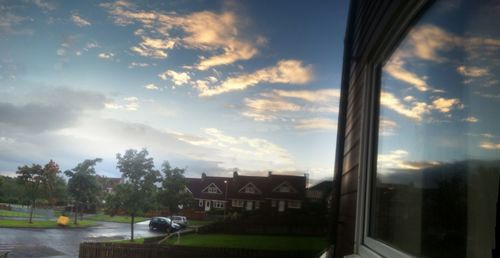 Buildings against cloudy sky