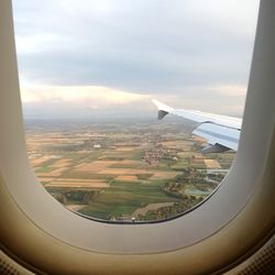 Cropped image of airplane wing over sea