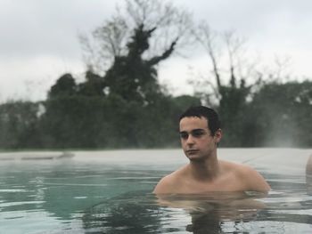 Young man swimming in pool