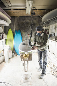 Surfboard shaper refining a new design