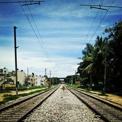 Railroad track against cloudy sky