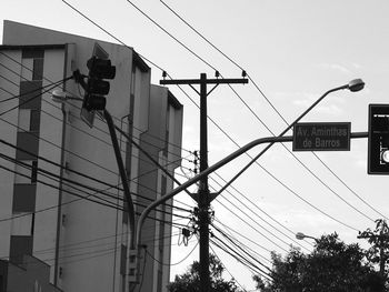 Low angle view of road sign against sky