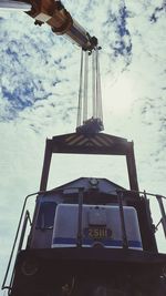 Low angle view of crane against sky