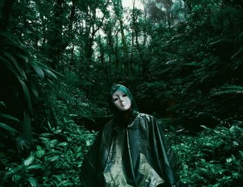 Portrait of smiling young woman in forest