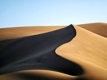 Scenic view of desert against clear sky