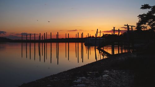 Scenic view of river against sky during sunset