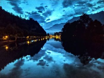 Scenic view of lake against sky at night