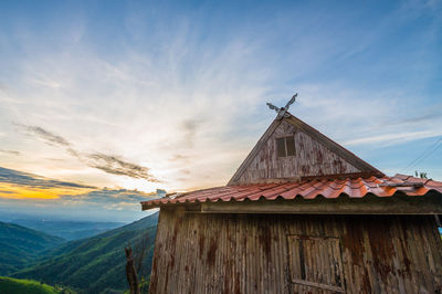 Traditional building on mountain against sky