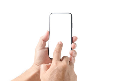 Midsection of man holding smart phone against white background