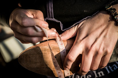 Close-up of person measuring shoe