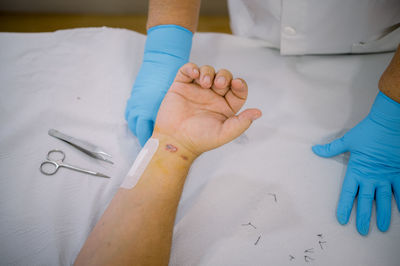 Cropped hand of doctor giving medicine