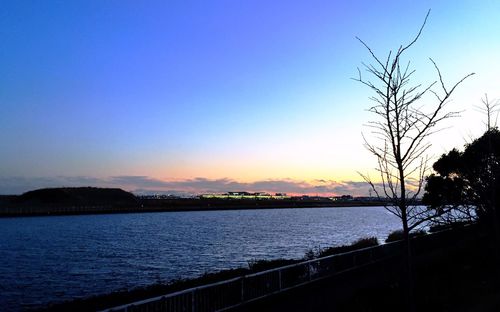 Scenic view of sea against clear sky at sunset