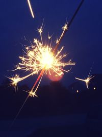 Low angle view of firework display at night