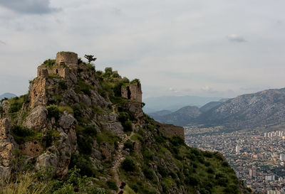 Castle on mountain against sky