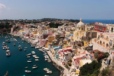 High angle view of town by sea against clear sky