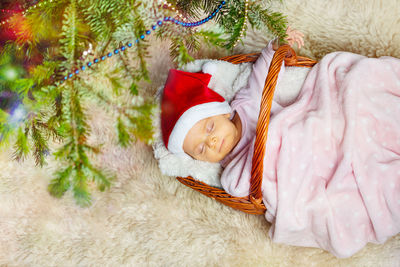 High angle view of cute baby boy sleeping on bed