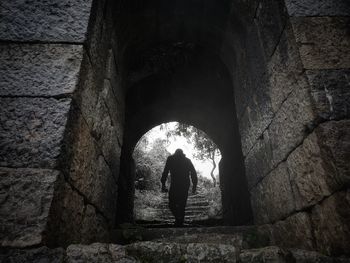 Rear view of man standing in tunnel