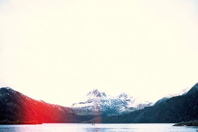 Scenic view of lake against clear sky during winter