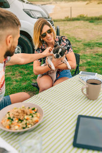 Couple with dog sitting outdoors