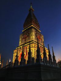 Low angle view of illuminated building against sky