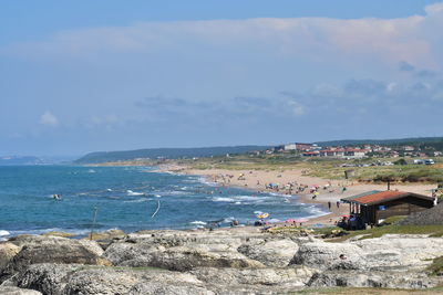 Building against the sea and people on the beach