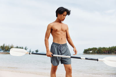 Rear view of man exercising in gym