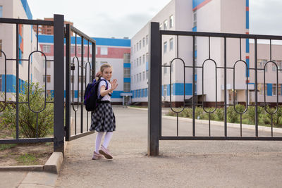 Back to school. girl in school uniform go to school with backpack behind their backs. beginning of 