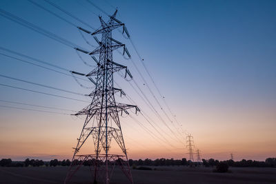 Transmission power, power tower on an empty farm land at the sunset. aerial drone photograph.