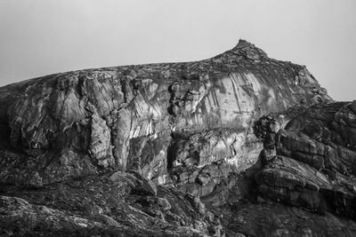 Low angle view of rock formation against clear sky