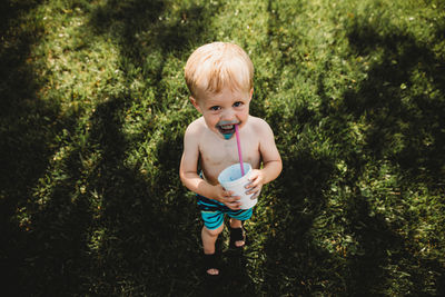 Smiling toddler boy with blue face from snowcone