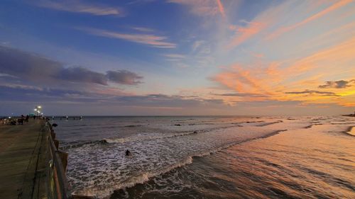 Scenic view of beach against sky during sunset