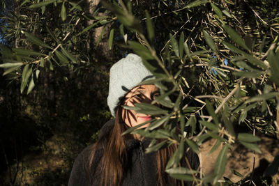 Woman looking away by plants