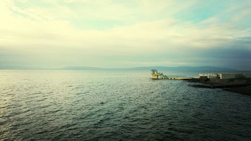 Scenic view of sea against cloudy sky