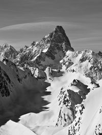 Scenic view of snow covered mountains against sky