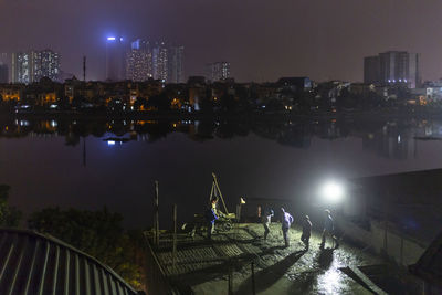 High angle view of illuminated buildings in city at night