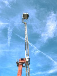 Low angle view of crane against sky