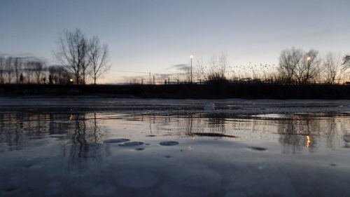 Frozen lake against sky during winter