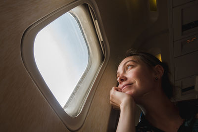 Woman at porthole in plane