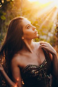 Beautiful young woman looking up