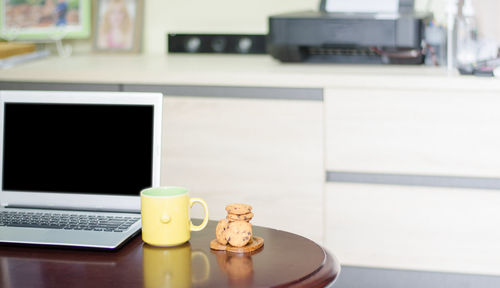 Close-up of coffee cup on table at home