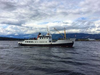 Ship sailing on sea against sky