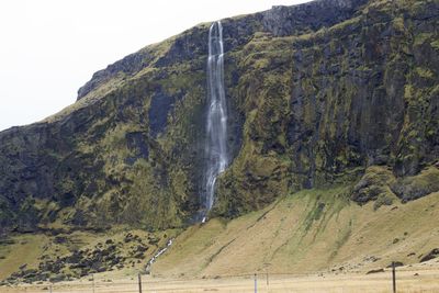 Scenic view of waterfall against sky