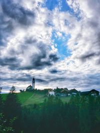 Scenic view of field against cloudy sky