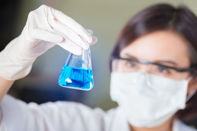 Female scientist holding medical sample at laboratory