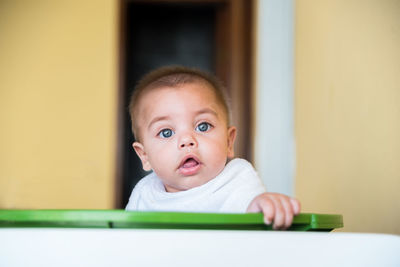 Close-up of baby boy in container at home